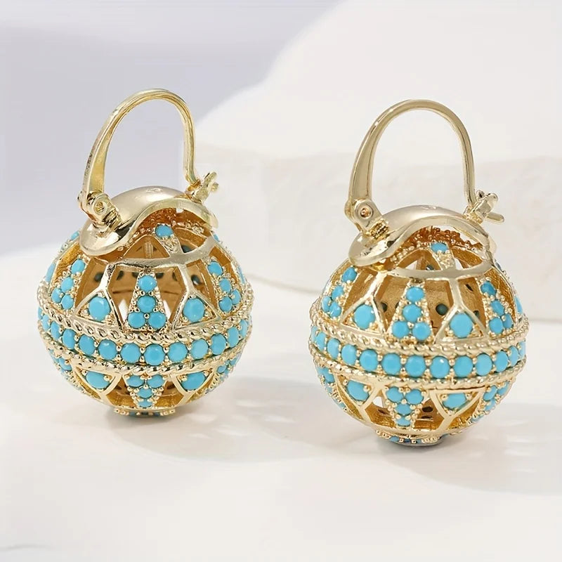 Boucles d'oreilles mandala dorées turquoise de Danoir Paris, détails or et design élégant.