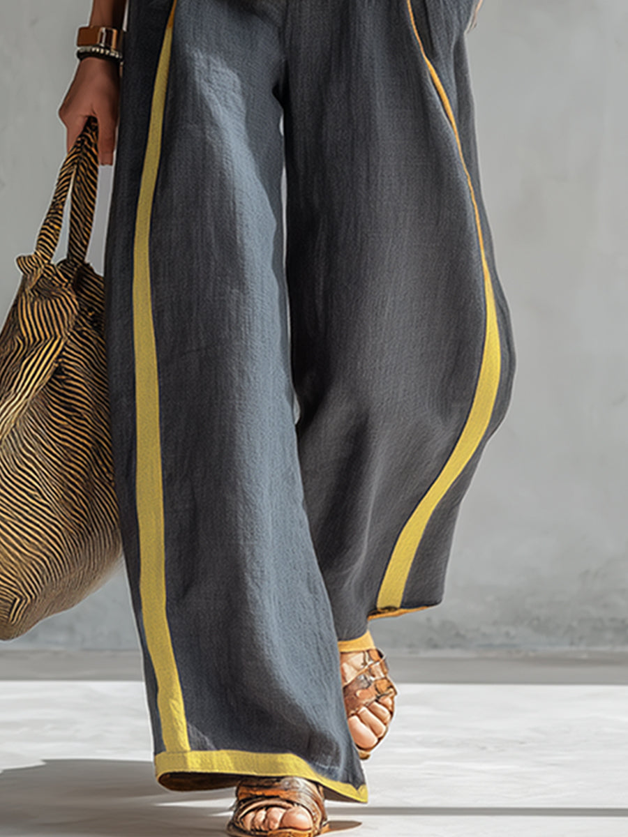 Ensemble deux pièces élégant Leila de Danoir Paris, top gris et pantalon assorti, porté par un mannequin.