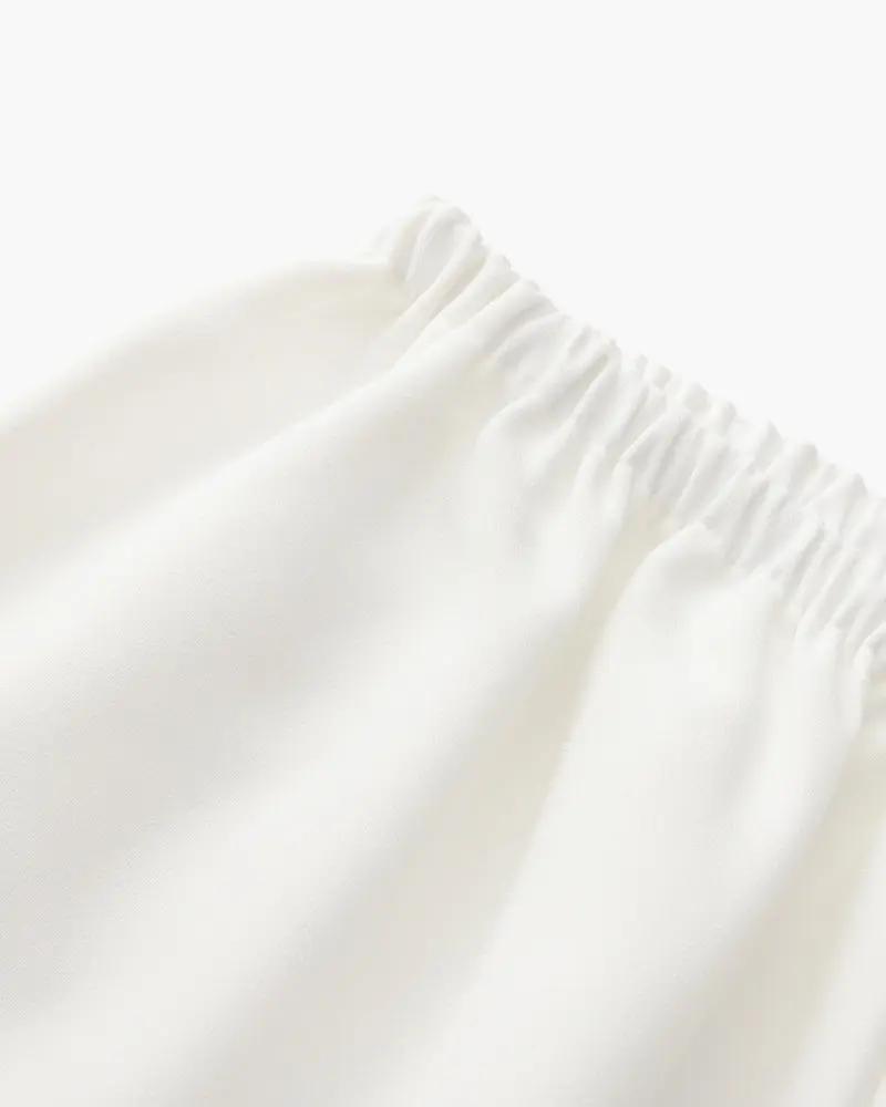 Pantalon Palais en ivoire de la marque Danoir Paris, coupe élégante et tissu doux visible sur l'image.