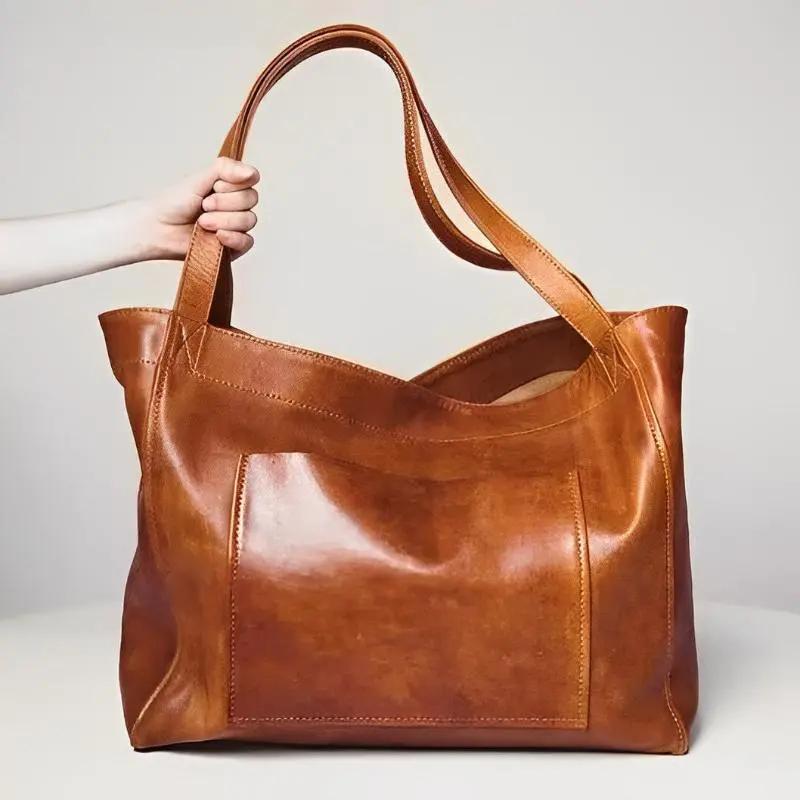 Sac en cuir rétro Élise de Danoir Paris, sac à main marron élégant avec poignées et détails vintage visible en image.