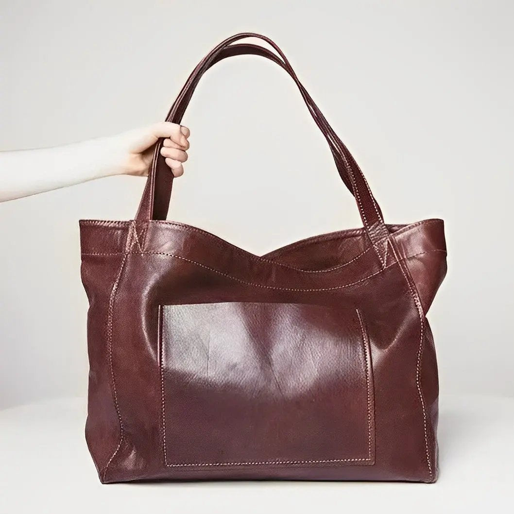 Sac en cuir rétro Élise de Danoir Paris, marron, avec poignée et détails vintage visible sur l'image.