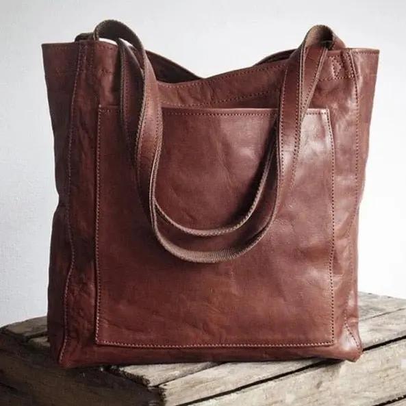 Sac de ville élégant Lila de Danoir Paris, en cuir marron, avec poignées et design sophistiqué visible sur l'image.