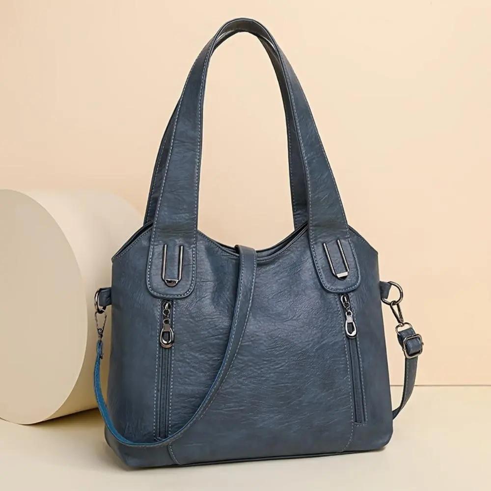 Sac à bandoulière Danoir Paris Lydia en cuir marron avec charme vintage, détail élégant et bandoulière ajustable.