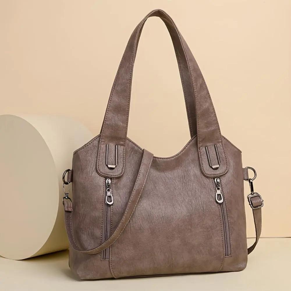 Sac à bandoulière Danoir Paris Lydia en cuir marron avec design vintage, élégant et pratique pour un style rétro sophistiqué.