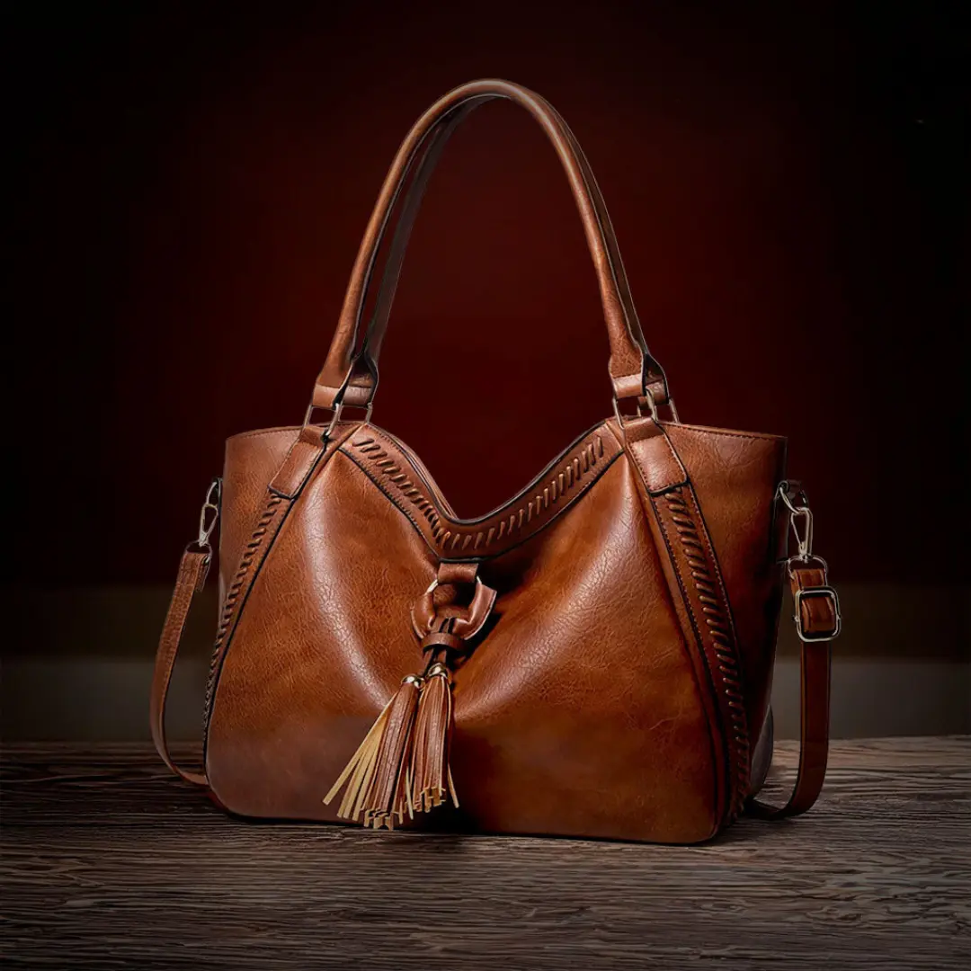 Sac à bandoulière marron Lydia de Danoir Paris, élégant et intemporel, en cuir avec poignées et fermeture métallique.