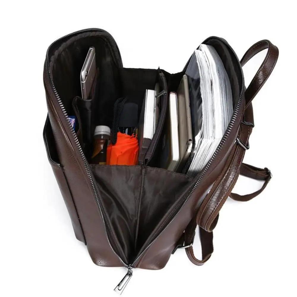Sac à main Naomi Danoir Paris en cuir marron avec deux zips, design intemporel et élégant, porté sur l'épaule.