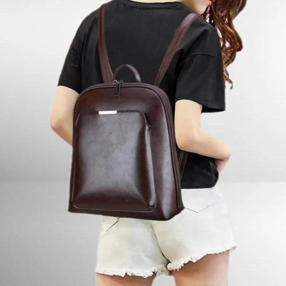 Sac Naomi Danoir Paris en marron avec deux zips, design intemporel et élégant, sac à main en cuir sophistiqué.