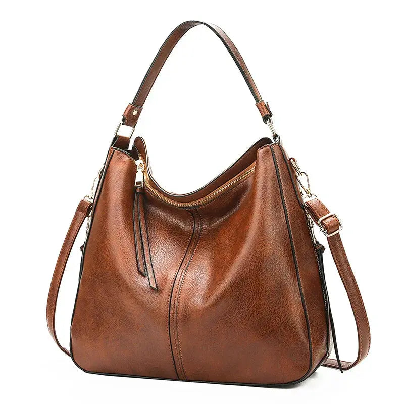 Sac élégant Romy en cuir marron de Danoir Paris, avec poignées et fermeture métallique visible.