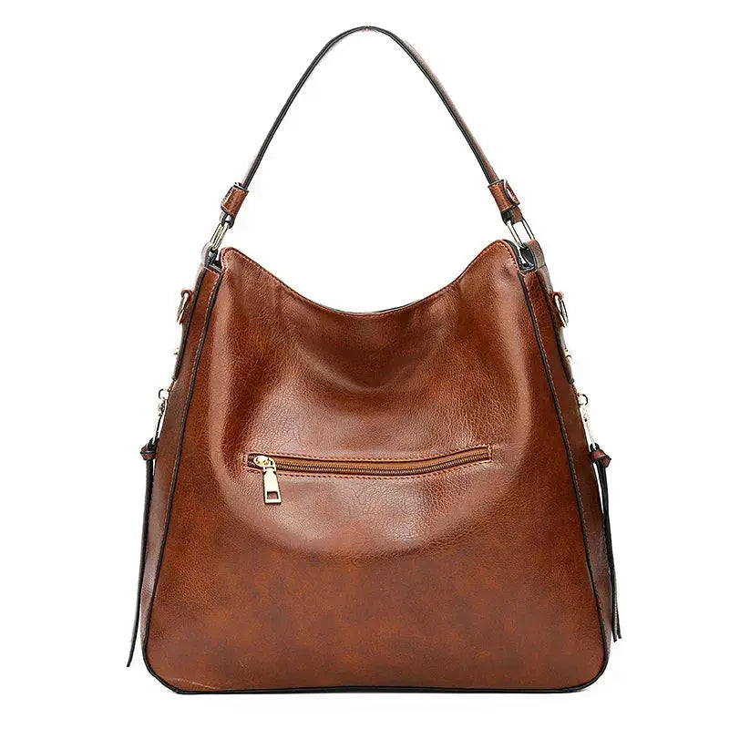 Sac élégant Romy en cuir marron de Danoir Paris, avec poignées et fermeture sophistiquée, pour un look chic et raffiné.