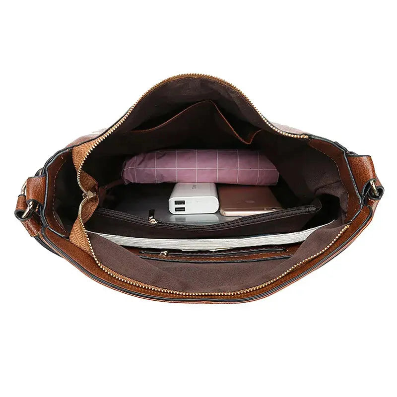 Sac à main en cuir marron Romy de Danoir Paris, élégant et sophistiqué, avec détails en cuir souple et finition raffinée.