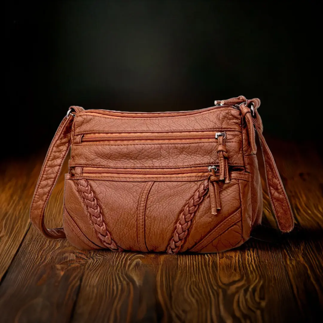 Sac à main marron Danoir Paris Talia, sac d'élégance intemporelle en cuir avec poignées et détails raffinés.