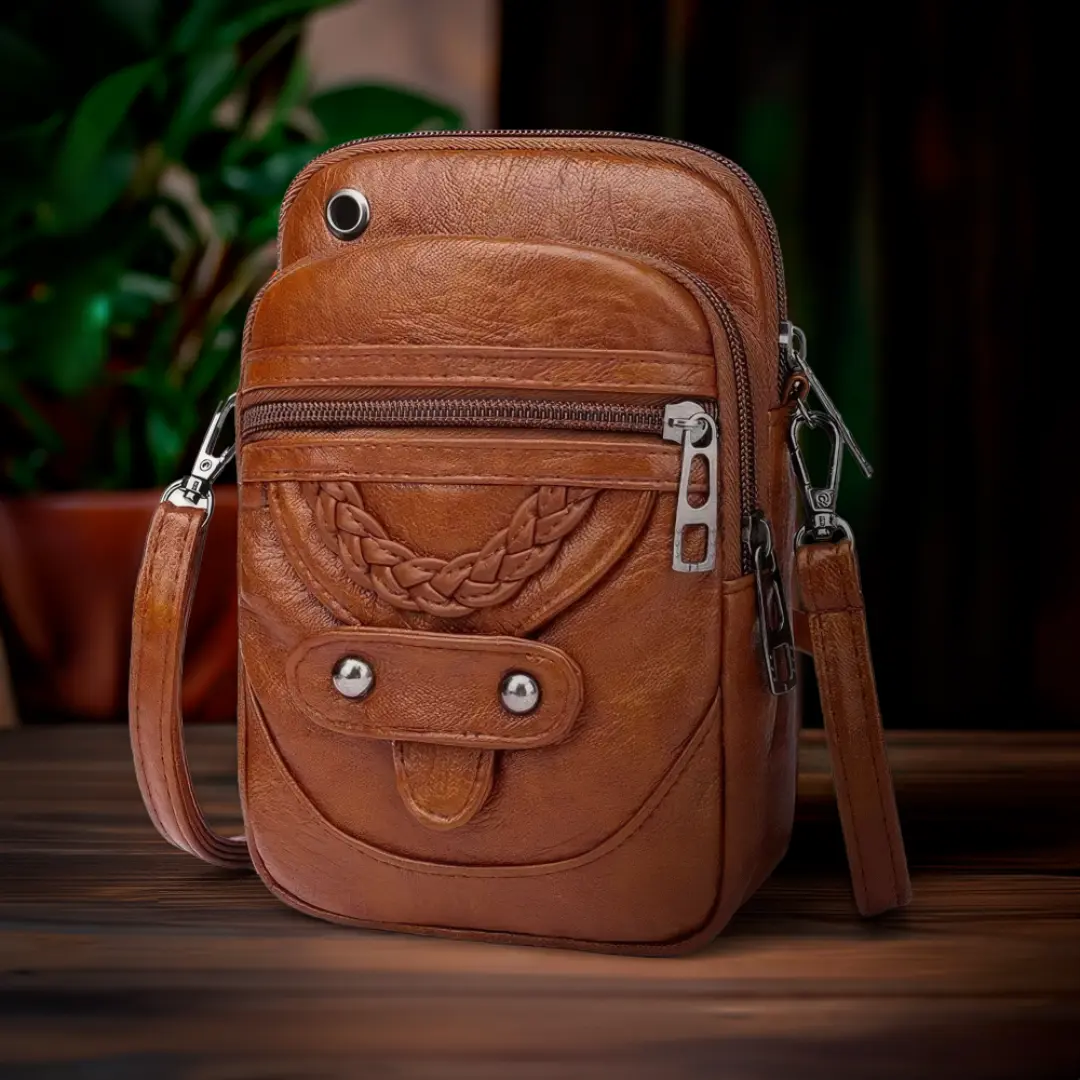 Sac à bandoulière Tamsin de Danoir Paris en marron, élégant sac en cuir avec poignées et détails classiques.