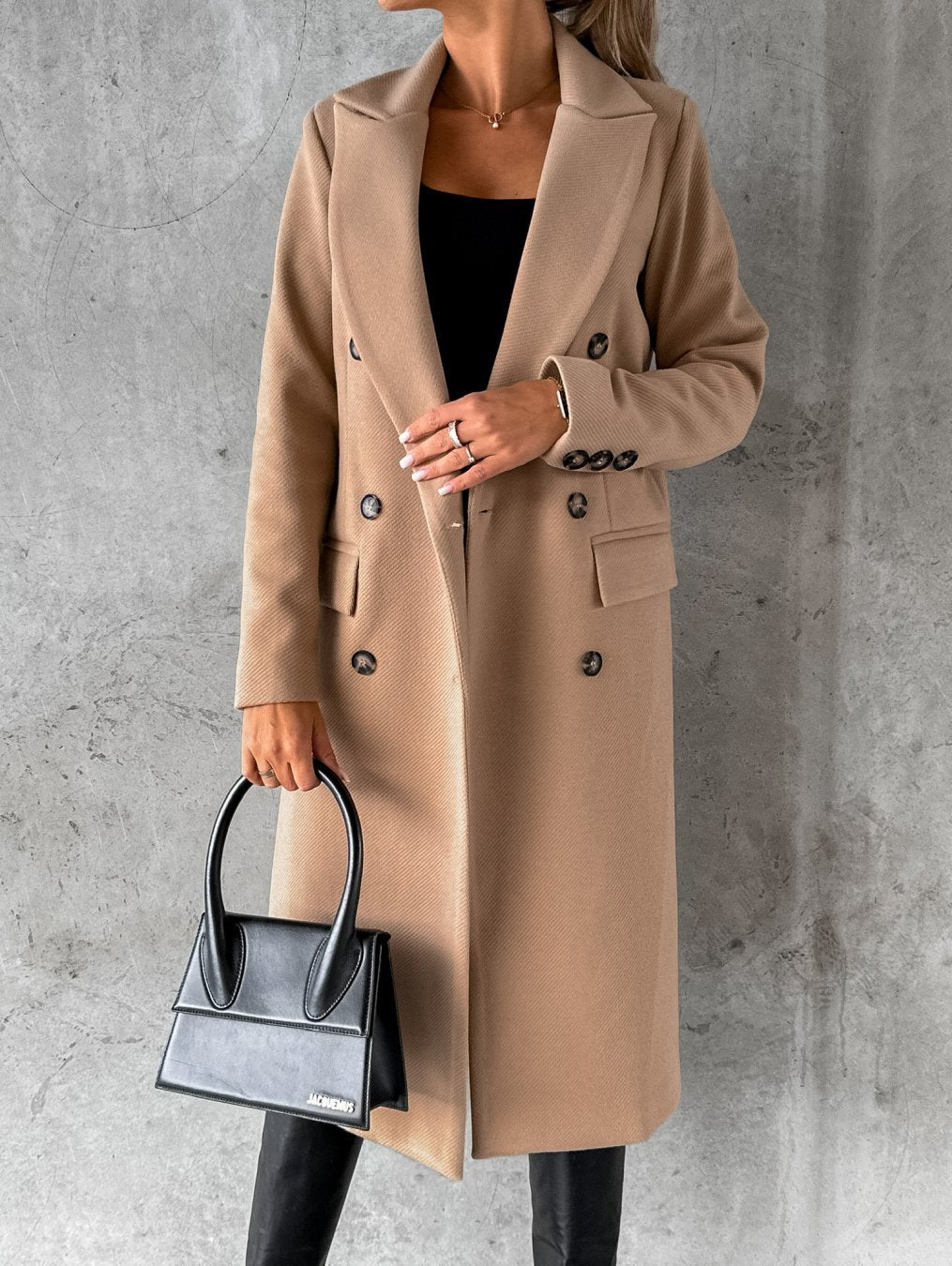 Manteau intemporel noir Jolie de Danoir Paris, élégant, en tissu chaud et confortable, porté en extérieur.