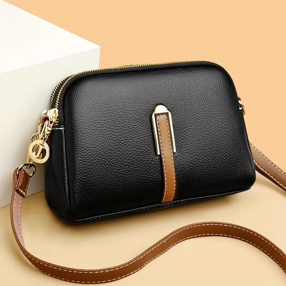 Sac bandoulière noir Danoir Paris Sienna, en cuir confortable et élégant, avec poches pratiques pour un style chic et fonctionnel.