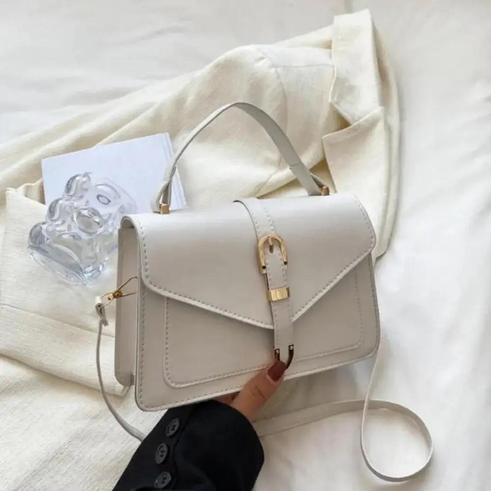 Sac à bandoulière noir Danoir Paris Tessa, élégant et minimaliste, avec poignée en cuir et design épuré.