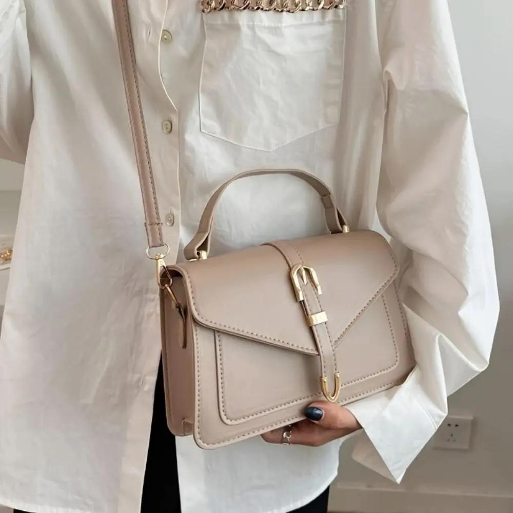 Sac à bandoulière noir Danoir Paris Tessa, élégant et minimaliste, avec poignée en cuir et design épuré.