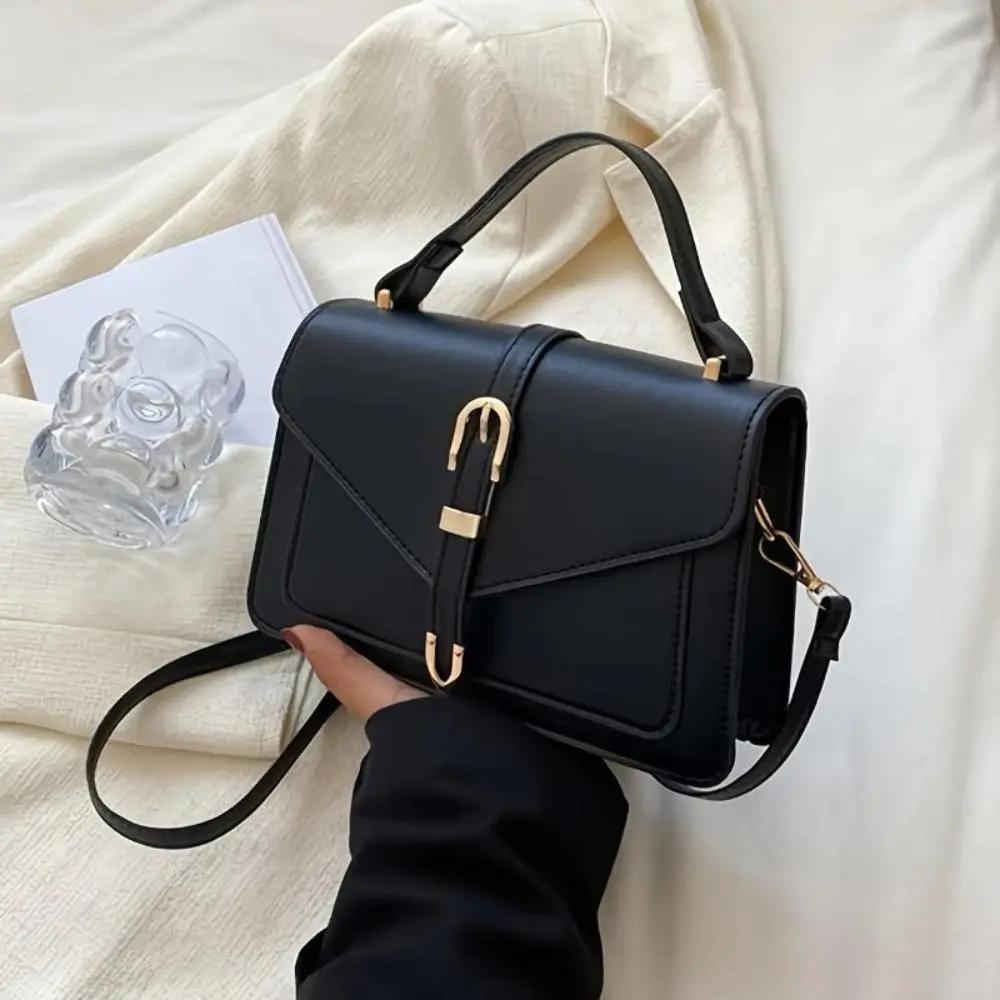 Sac à bandoulière Tessa de Danoir Paris, élégant et minimaliste, en noir avec finition sophistiquée.