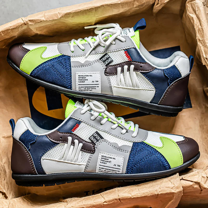 Sneakers rétro colorées Giovanni de Danoir Paris en orange, vue de côté, avec semelle blanche et design vintage.
