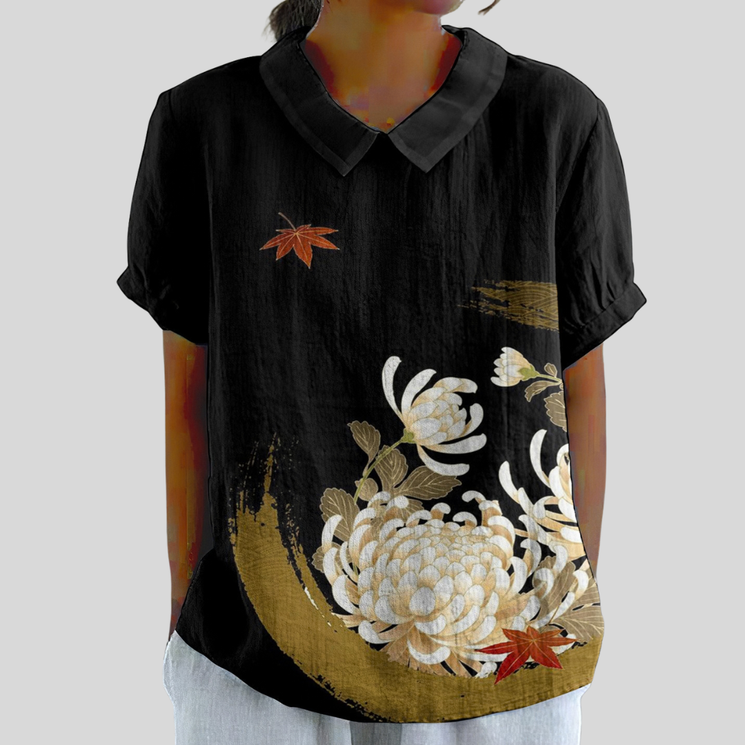 Blouse élégante noire à motifs floraux de la marque Danoir Paris, style Madeleine, tissu léger et détails sophistiqués.