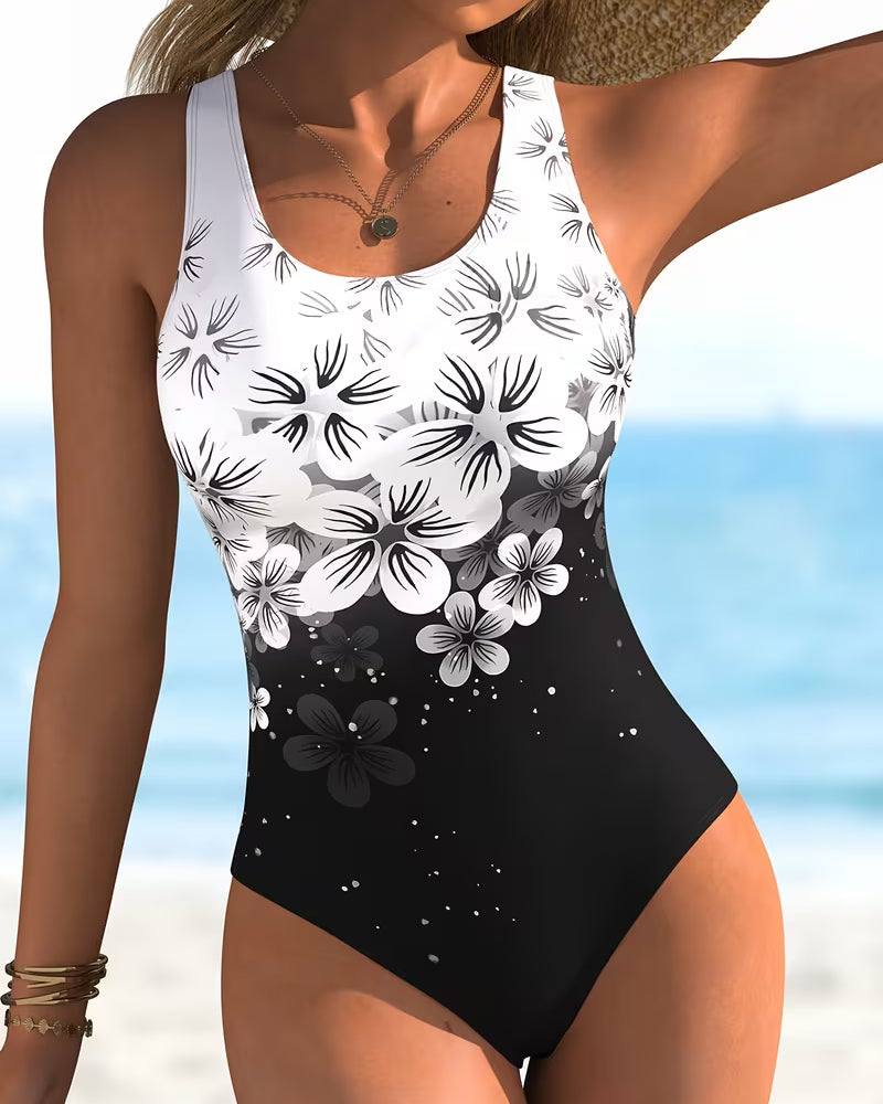 Maillot de bain une pièce Danoir Paris à imprimé fleuri en noir, avec coupe élégante et détails modernes.