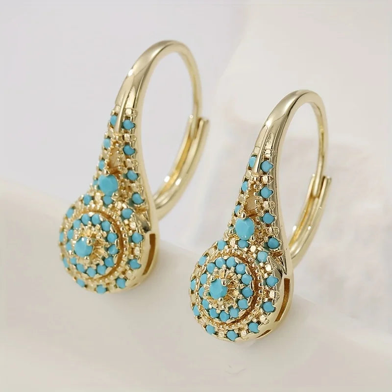 Boucles d'oreilles Danoir Paris Gilded Turquoise Bloom avec pierre turquoise et finition dorée élégante.