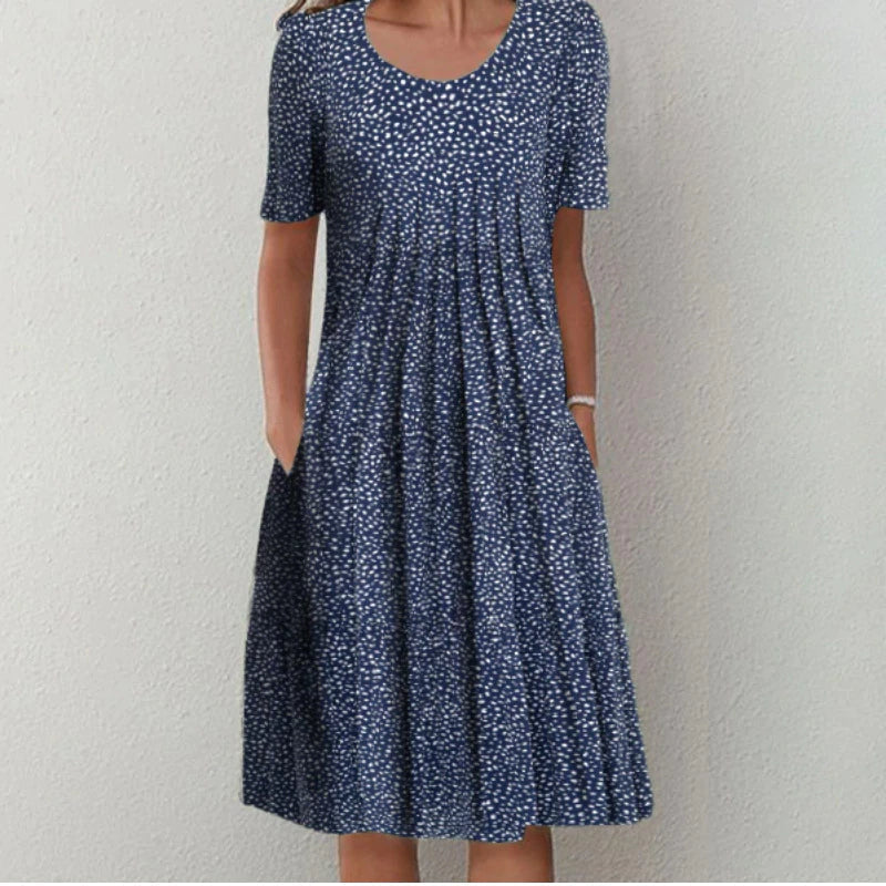 Robe midi élégante pour femme Danoir Paris, légère et aérée, avec motif floral multicolore sur fond blanc.