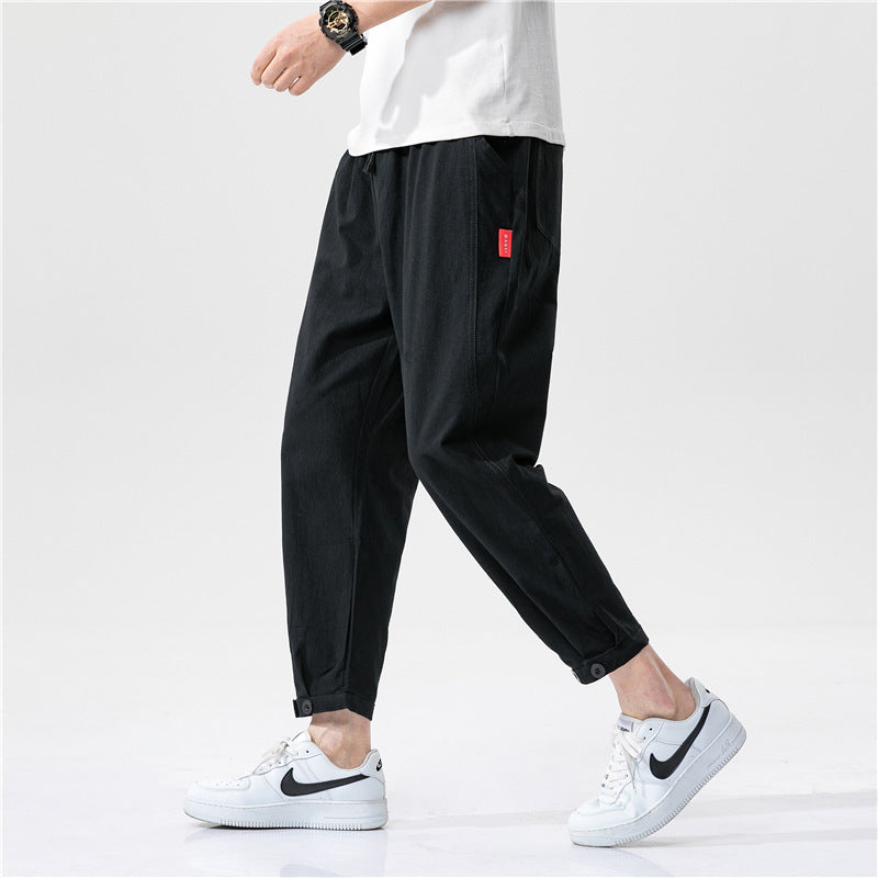 Pantalons ajustés en coton Theo de Danoir Paris, coupe moderne, tissu doux, couleur neutre, parfait pour un style décontracté.