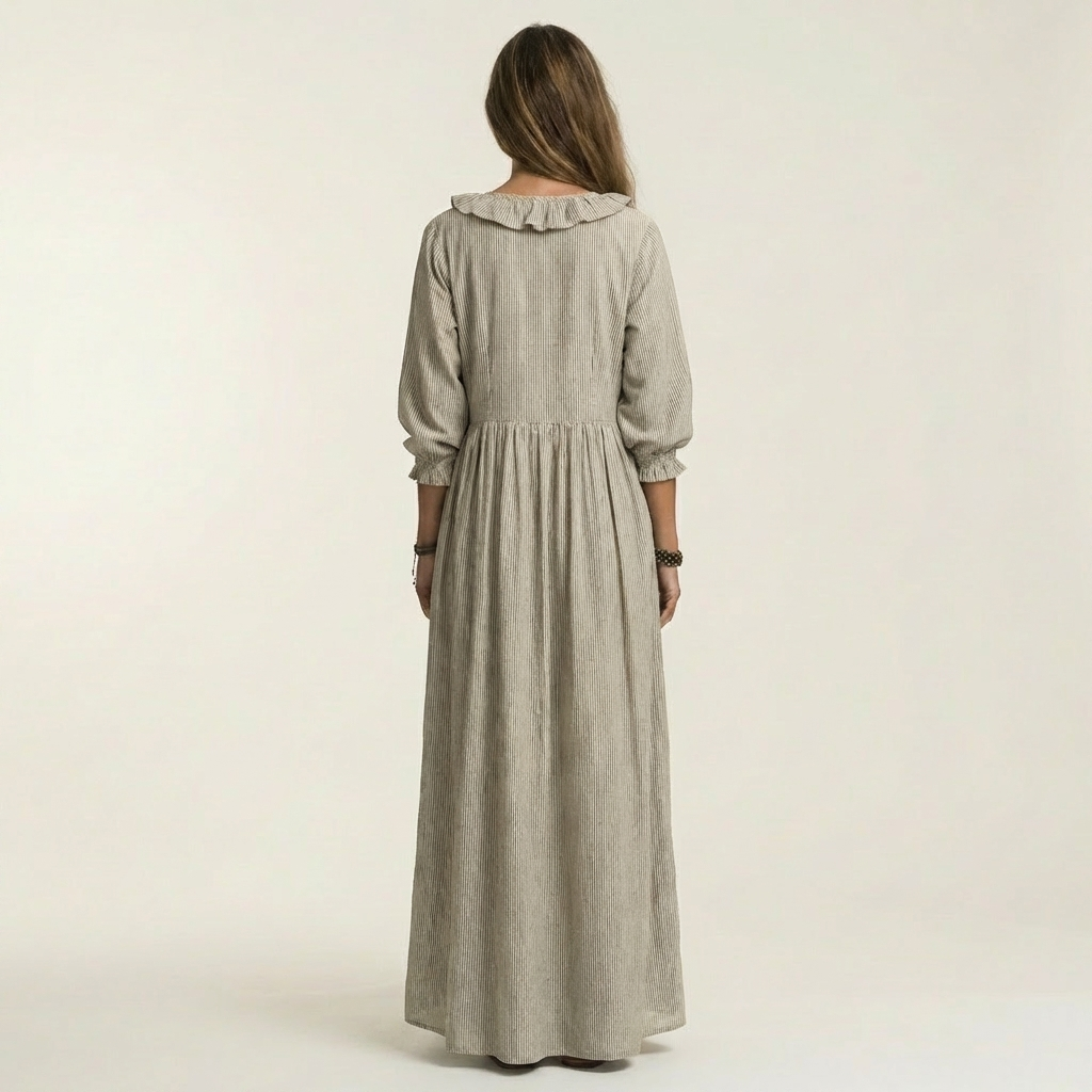 Robe maxi rayée Danoir Paris avec volants et décolleté en V, tissu léger et élégant, portée en mode décontracté ou chic.
